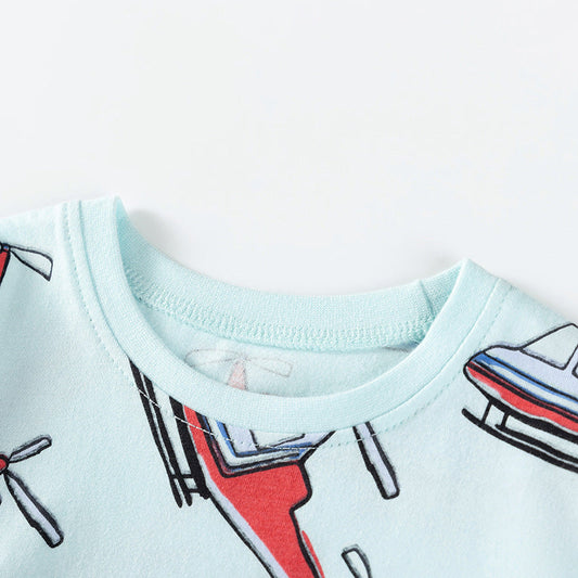 Light blue shirt with airplane designs on a white background