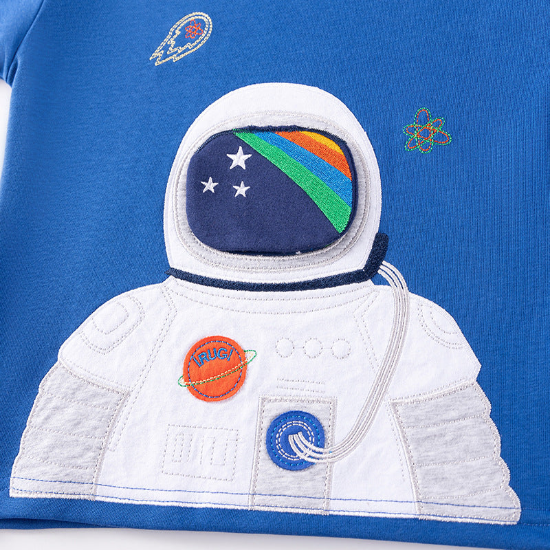 Close-up of a blue t-shirt with an astronaut design and space-themed elements.