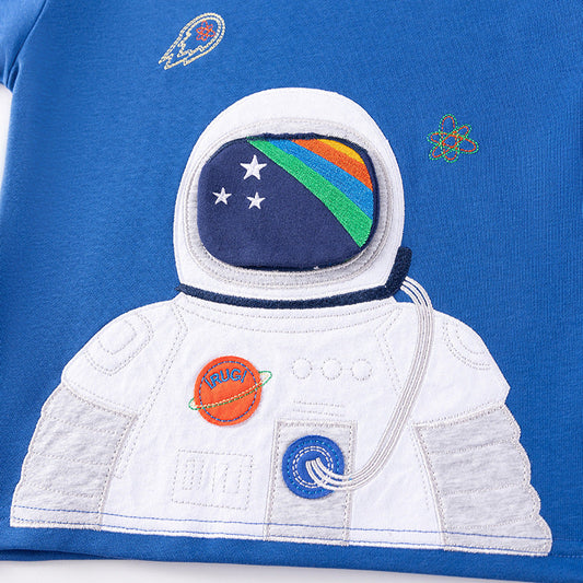 Close-up of a blue t-shirt with an astronaut design and space-themed elements.