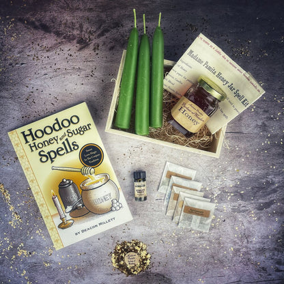 Hoodoo Honey and Sugar Spells kit with green candles, honey, and other items on a textured surface.
