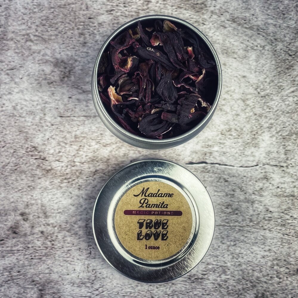 Metal tin with dried herbs on a textured surface