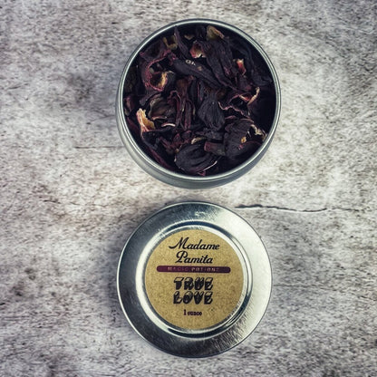 Metal tin with dried herbs on a textured surface