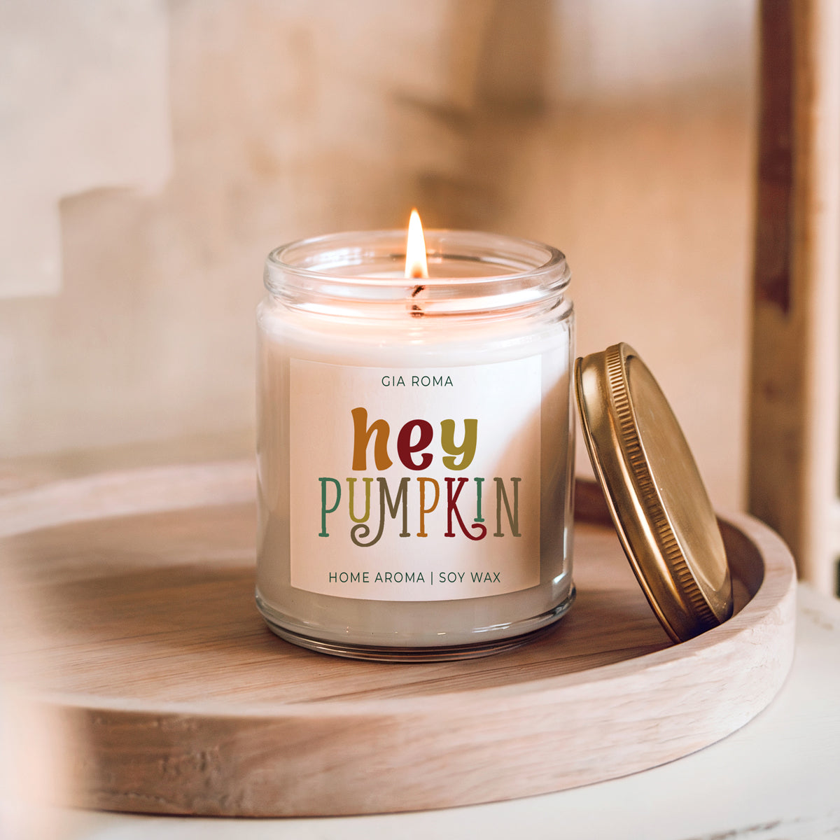 Candle labeled 'hey PUMPKIN' by Gia Roma on a wooden surface