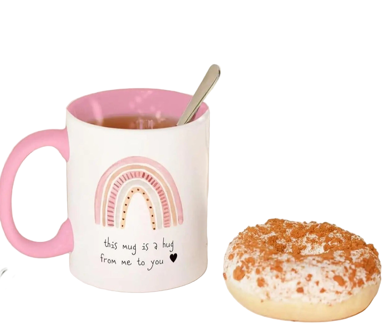 Mug with pink handle and rainbow design, next to a donut and notebook with text 'send a friend a hug'.