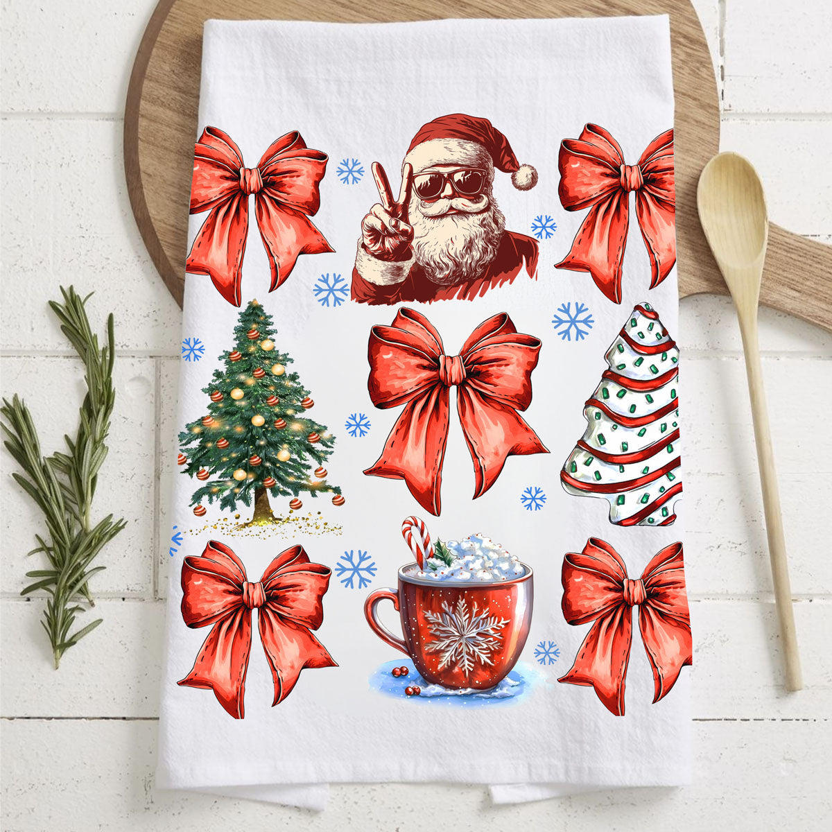 Decorative towel with Christmas-themed designs including Santa Claus, trees, and bows on a wooden surface.