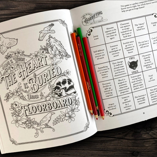 Open book with coloring page and text on a wooden surface
