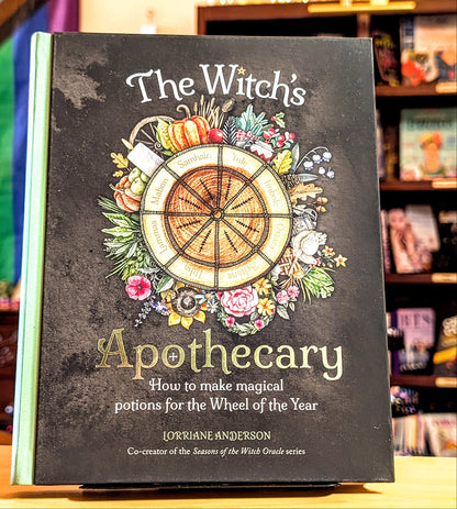 Book titled 'The Witch's Apothecary' on a shelf with colorful background