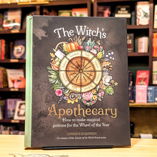 Book titled 'The Witch's Apothecary' on a shelf with books in the background