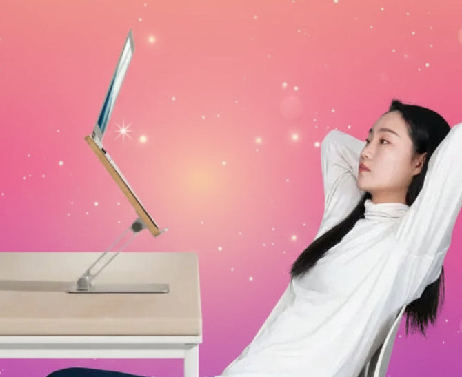 Person sitting at a desk with a modern chair and a light background