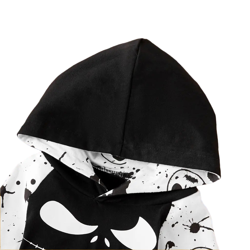 Black hooded garment with white abstract pattern on a beige background