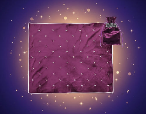 Purple satin bag with drawstring and matching fabric with star and moon patterns on a white background