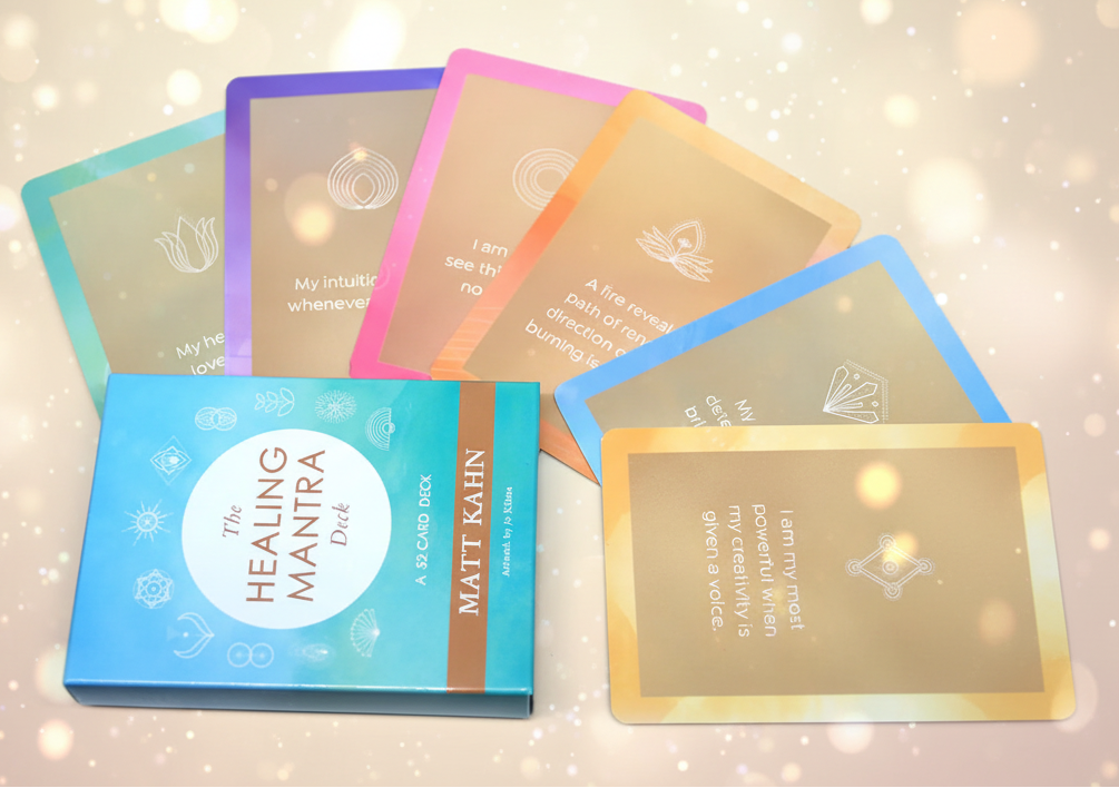 Set of 'The Healing Mantra' card decks on a light purple background