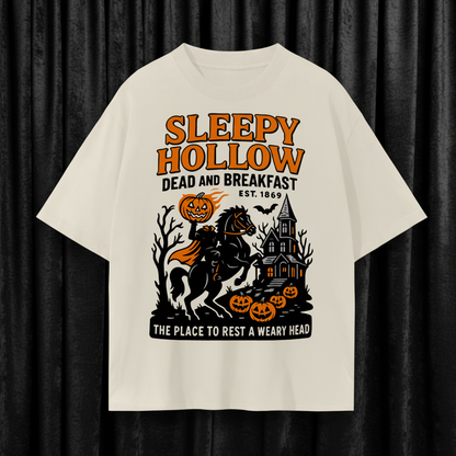Beige t-shirt with 'Sleepy Hollow Dead and Breakfast' graphic design on a white background