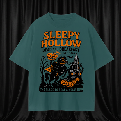 Teal t-shirt with Halloween-themed graphic and text on a white background