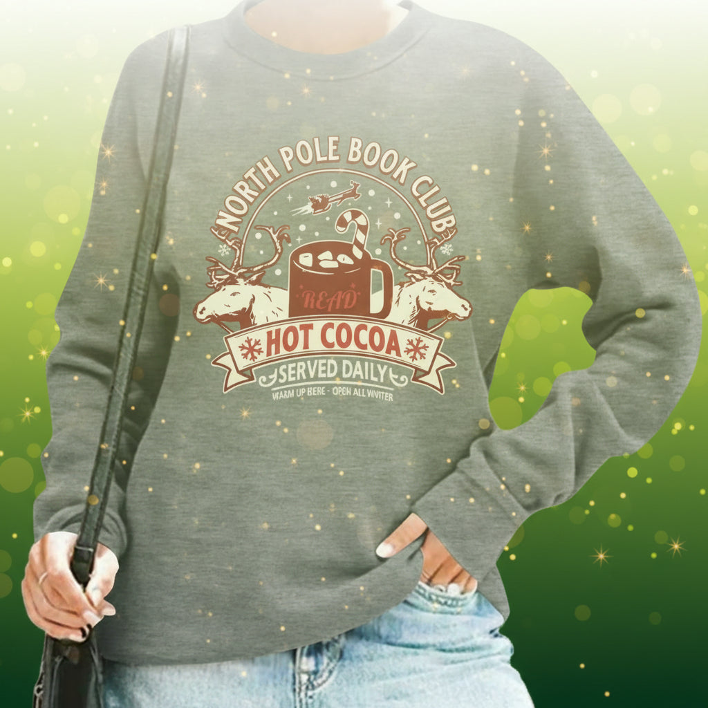 Gray sweatshirt with 'North Pole Book Club' design worn by a person.