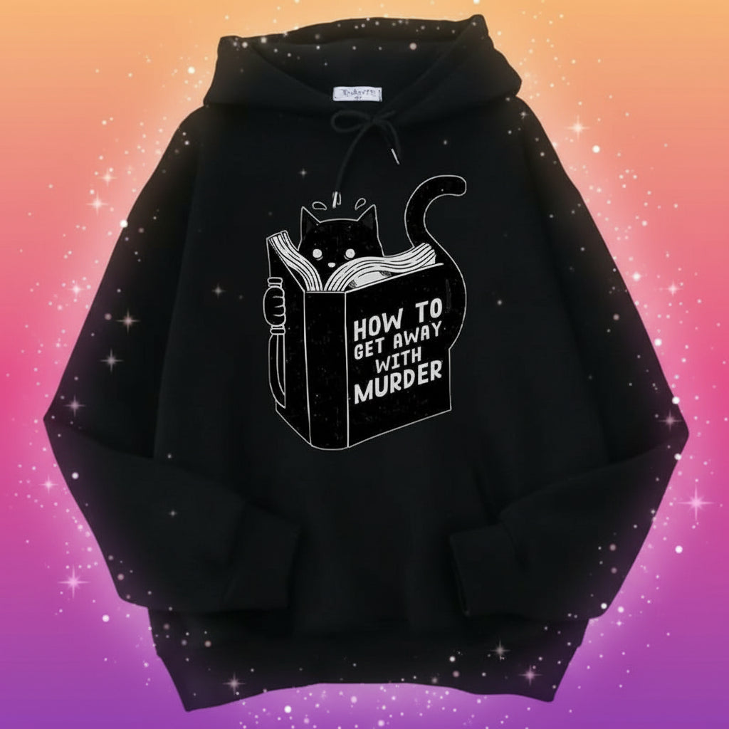 Black hoodie with a cat reading a book graphic and text on a surface.