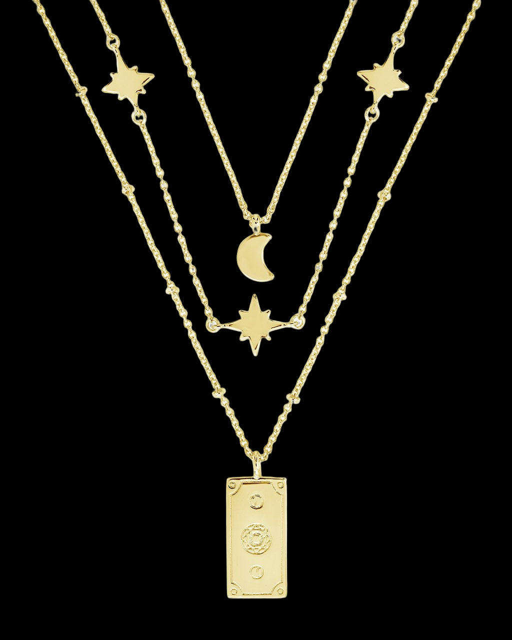 Three gold necklaces with star, moon, and rectangular pendant on a white background