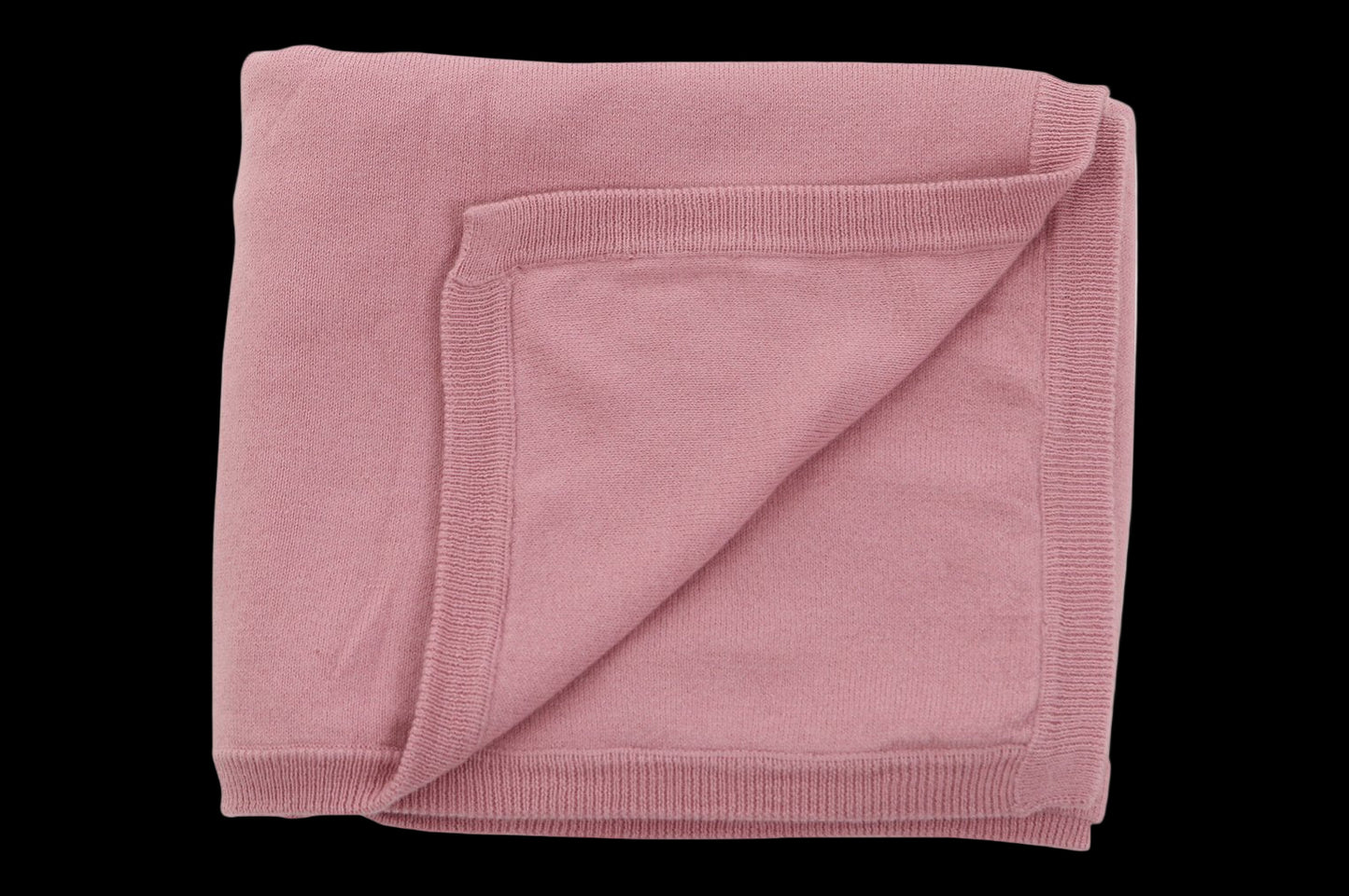 Folded pink blanket on a white background