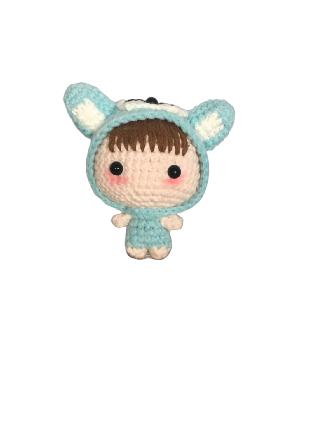 Crocheted toy with a blue hood and white accents on a textured surface
