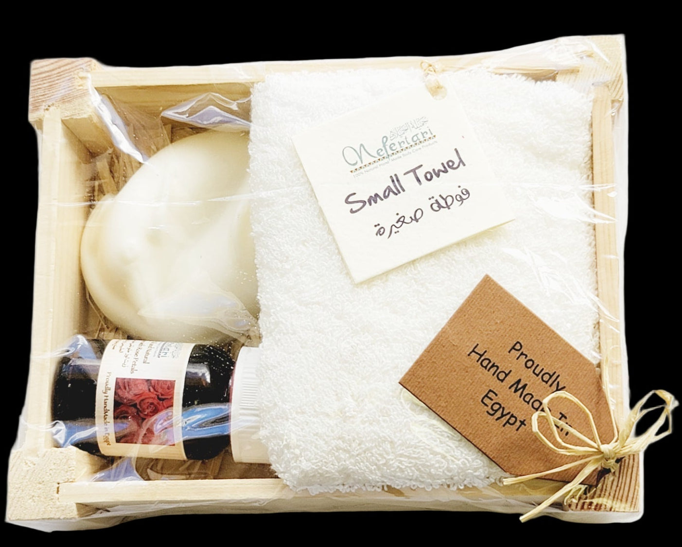 Gift set with soap, towel, and other items in a wooden box on a white background