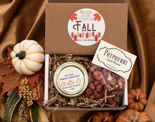Gift box with candle, potpourri, and decorative pumpkins on a checkered background