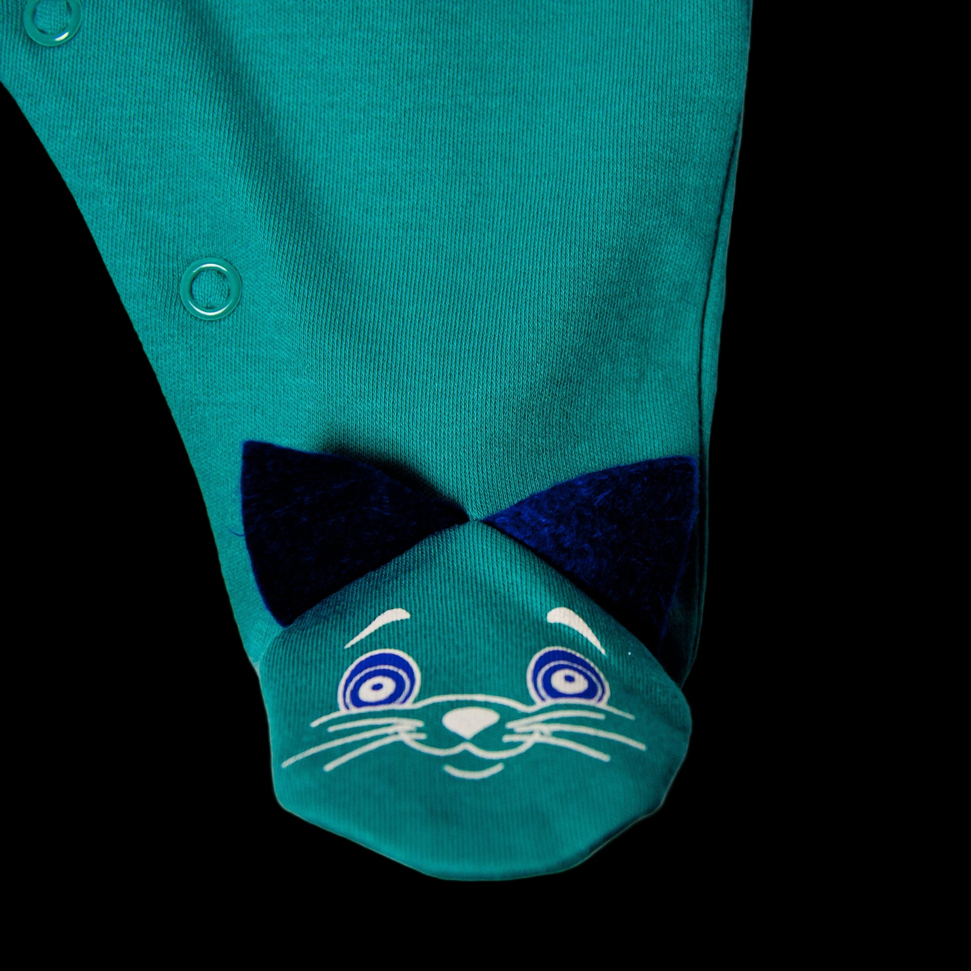Green baby romper with cat face design on a white background