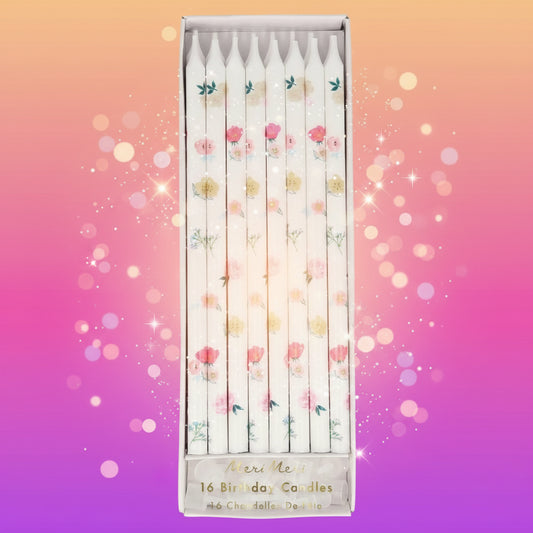 Set of floral birthday candles in a decorative box on a white background