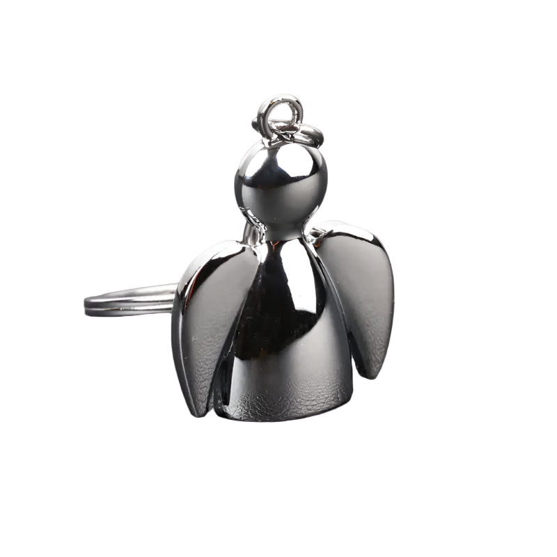 Silver angel-shaped keychain on a gray textured surface