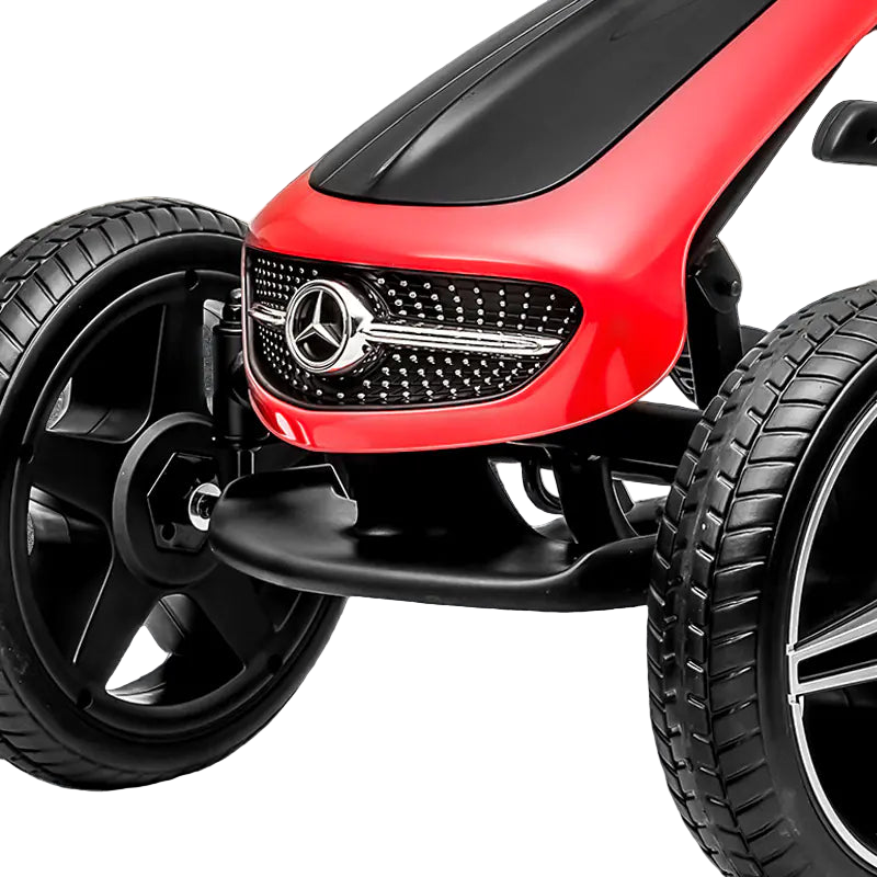 Close-up of a red toy car with a Mercedes-Benz logo on a black surface.