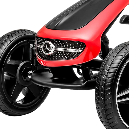 Close-up of a red toy car with a Mercedes-Benz logo on a black surface.