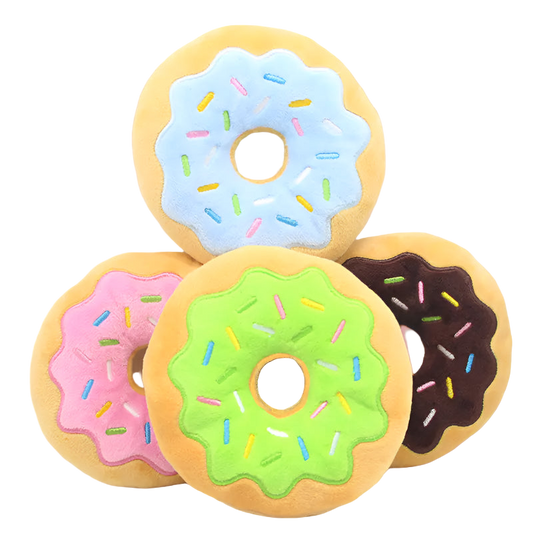 Four colorful donut-shaped cushions with different colored icing on a white background