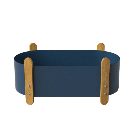 Blue pet bed with wooden sides on a gray background