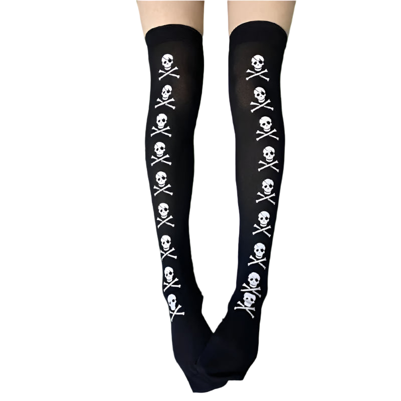 Black knee-high socks with skull and crossbones pattern on a gray textured surface