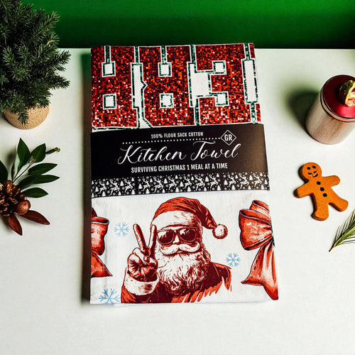 Cookbook with Santa Claus design on a festive background with Christmas decorations.
