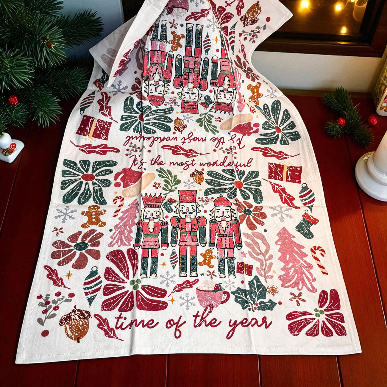Decorative towel with Christmas-themed design on a wooden surface