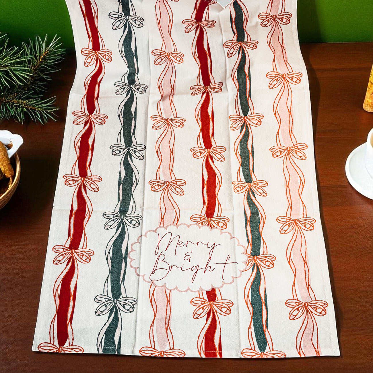 Decorative towel with candy cane and bow pattern on a wooden surface