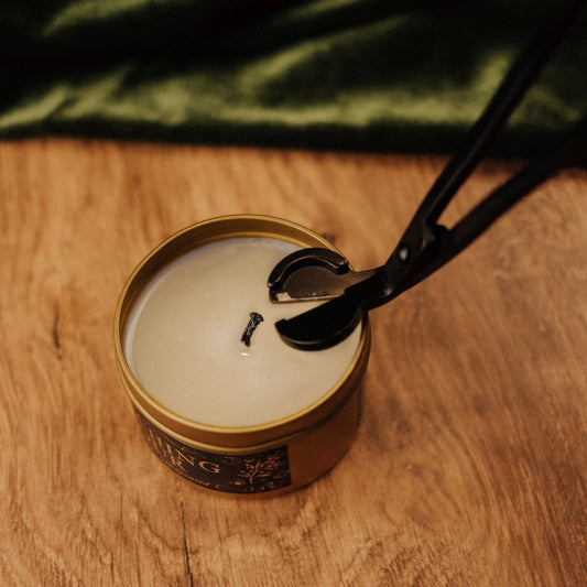 Candle being lit with a match on a wooden surface