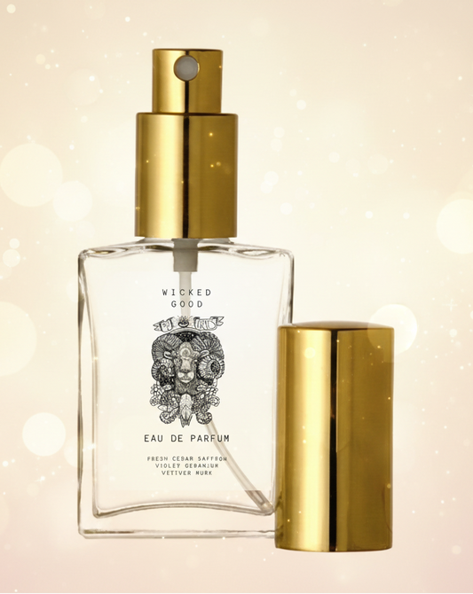 Perfume bottle with gold cap and clear label on a beige background