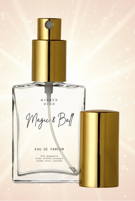 Perfume bottle with gold cap and 'Wicked Good' branding on a light background