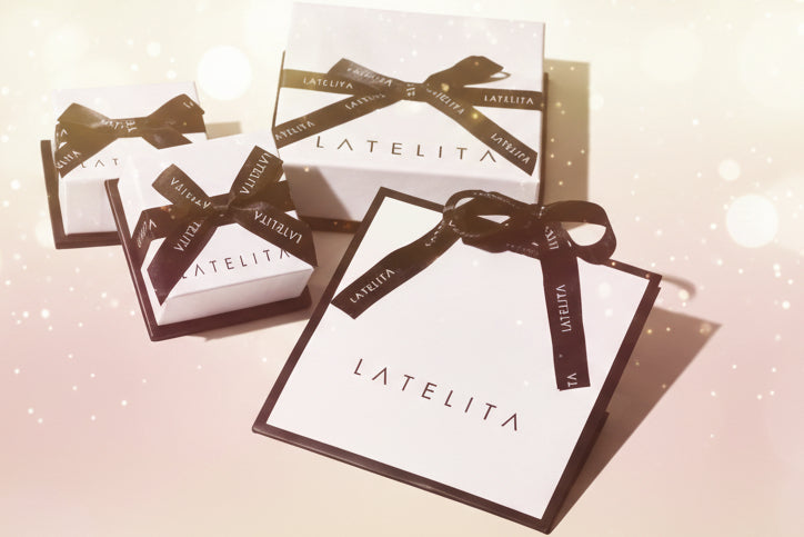 LATELITA boxes with black ribbons on a light background