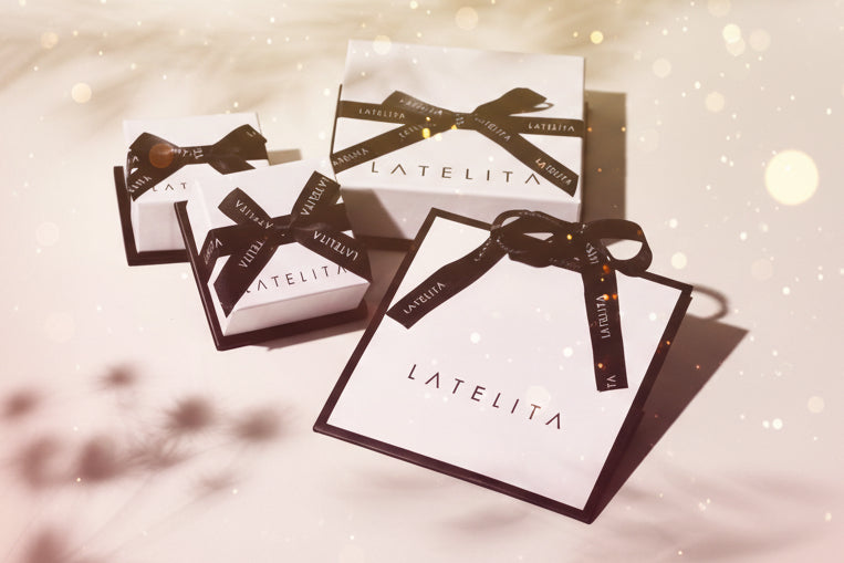 LATELITA boxes with black ribbons on a light background