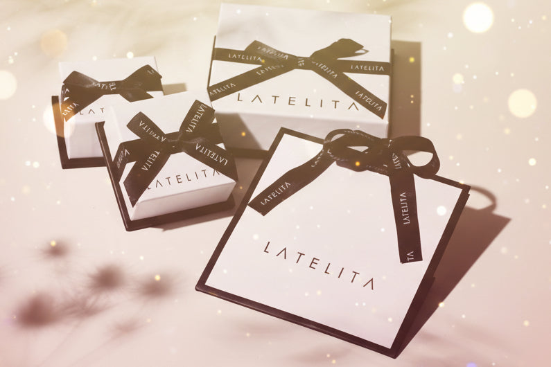 LATELITA boxes with black ribbons on a light background