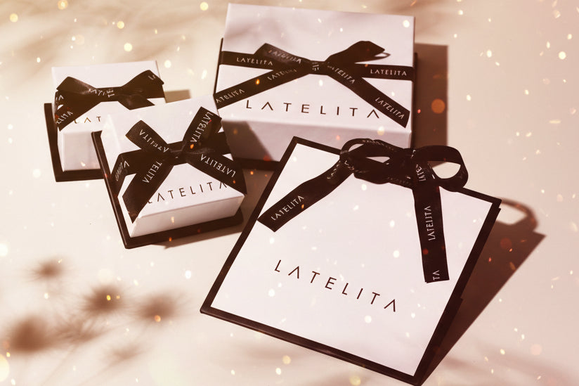 LATELITA boxes with black ribbons on a light background