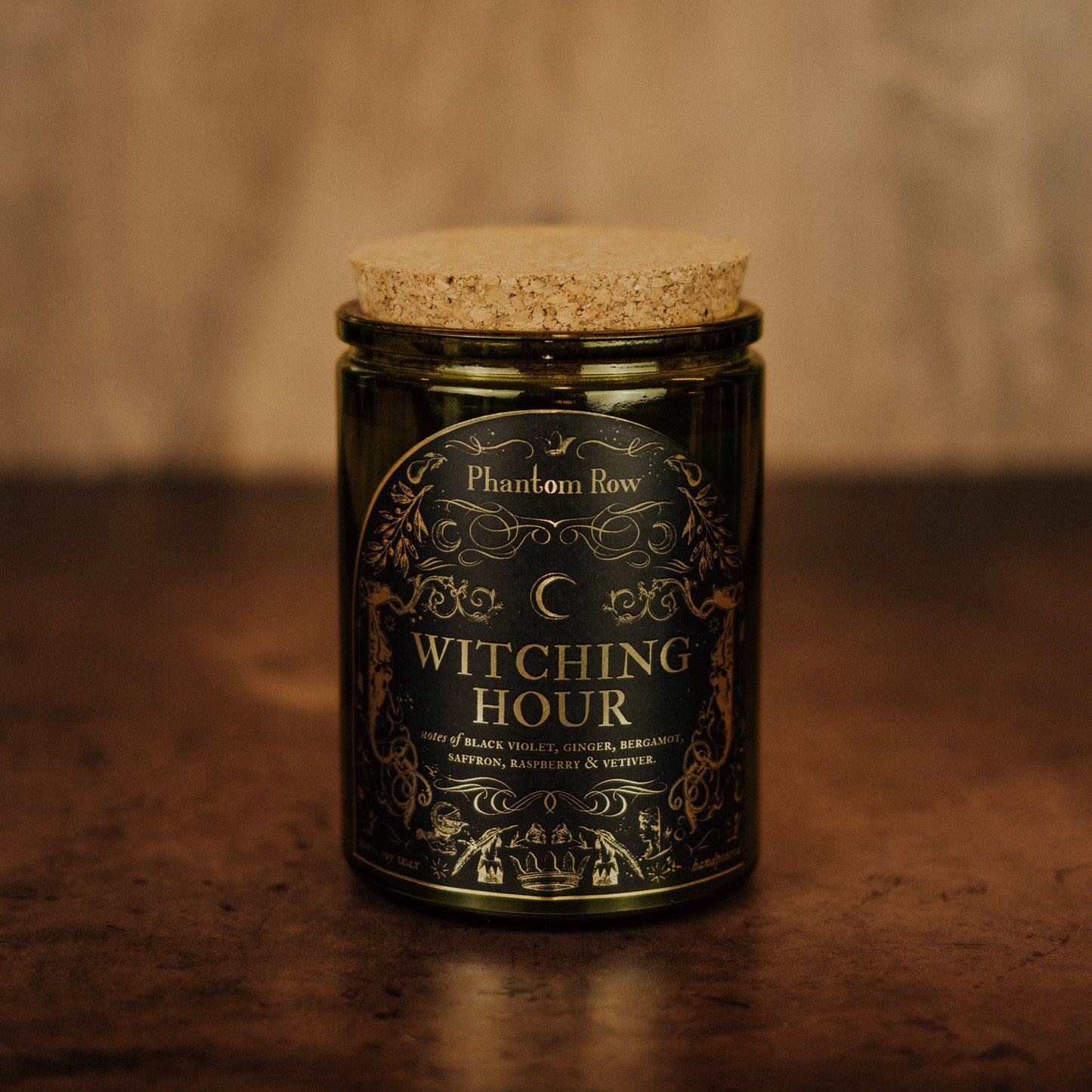 Candle jar labeled 'Witching Hour' by Phantom Row on a brown background