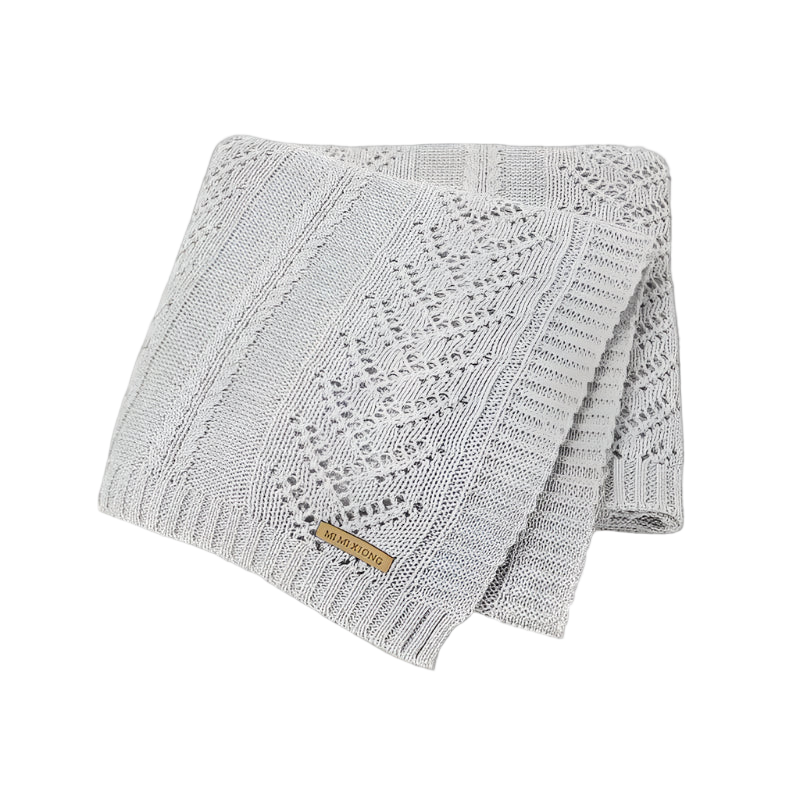 Gray knitted blanket with a brand label on a white background