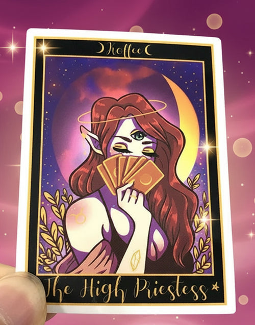 Card featuring 'The High Priestess' from a tarot card deck held in front of other cards.