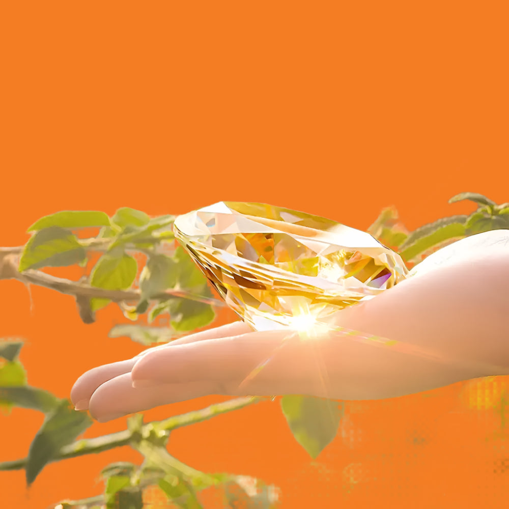 Hand holding a large diamond in front of a blurred natural background