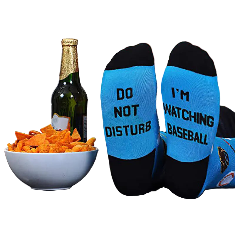 Two socks with humorous text on a table with snacks and a bottle.
