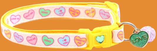 Cat collar with colorful heart patterns and a 'love' tag on a yellow background
