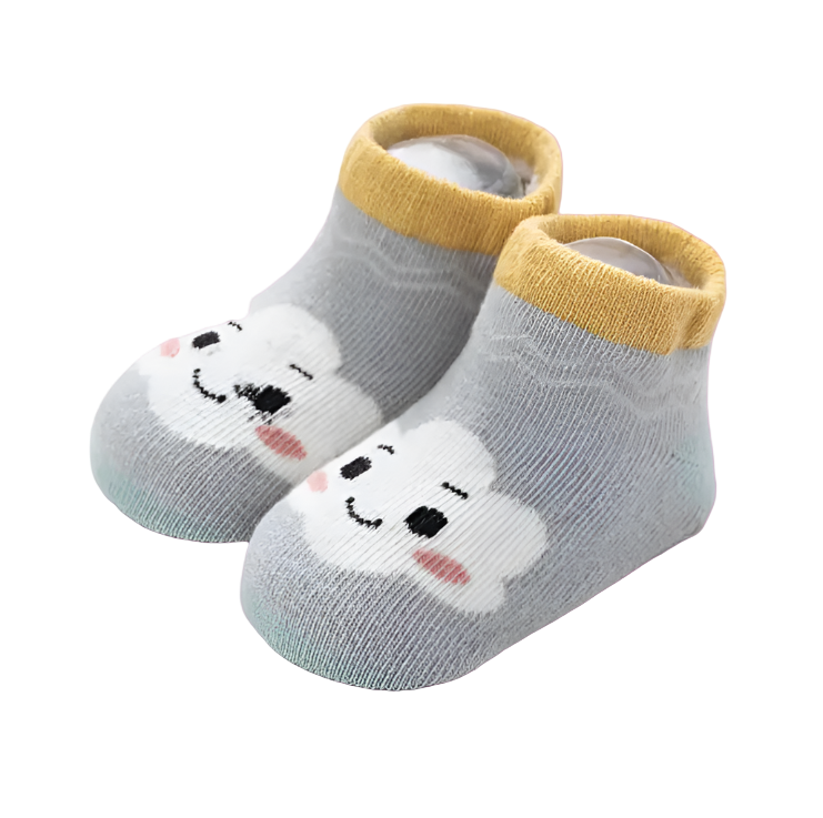 Pair of baby socks with cartoon dog design on a light background